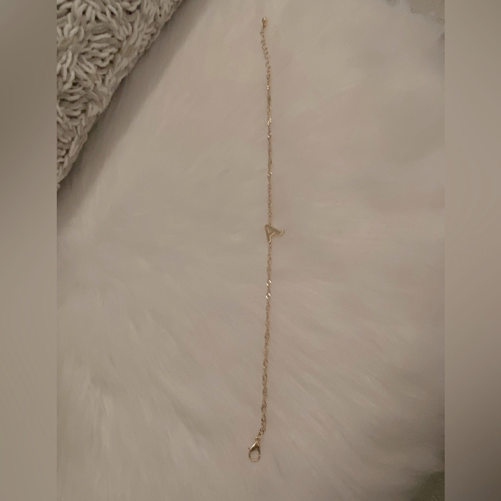 Letter A gold anklet with gem on initial.